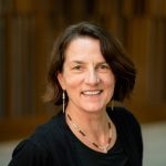 Nedra Chandler, a middle-aged white woman with short brown hair and brown eyes wearing a black blouse