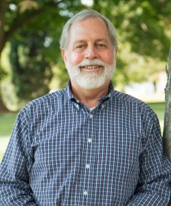 Bob Keiter, a senior man with white hair and beard wearing a blue plaid collared shirt