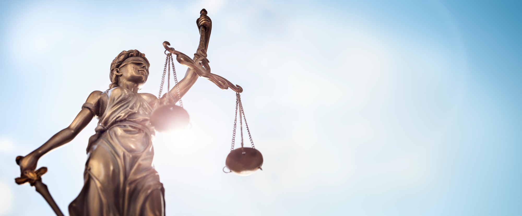 Legal and law concept statue of Lady Justice with scales of justice and sky background