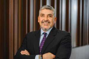 Dean Reyes Aguilar, a middle-aged Hispanic man with grey hair and a grey goatee