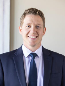 Aaron Christenson, a young white man with short, wavy brown hair