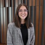 Eben Kohtz, a young Asian-American woman with shoulder-length brown hair and glasses